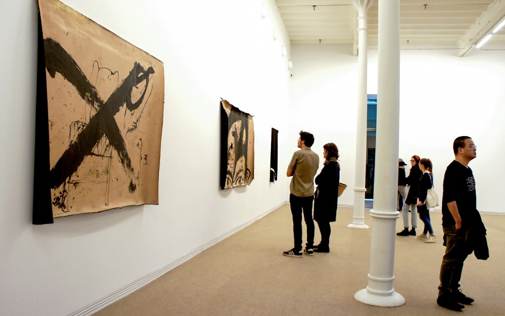 Visitors viewing abstract art at Fundació Antoni Tàpies, Barcelona.
