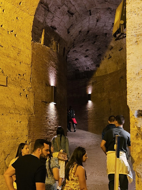 Visitors exploring the ancient corridors of Castel Sant'Angelo in Rome.