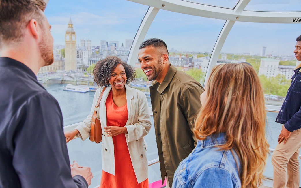 Group enjoying a ride on the London Eye with Big Ben in the background.