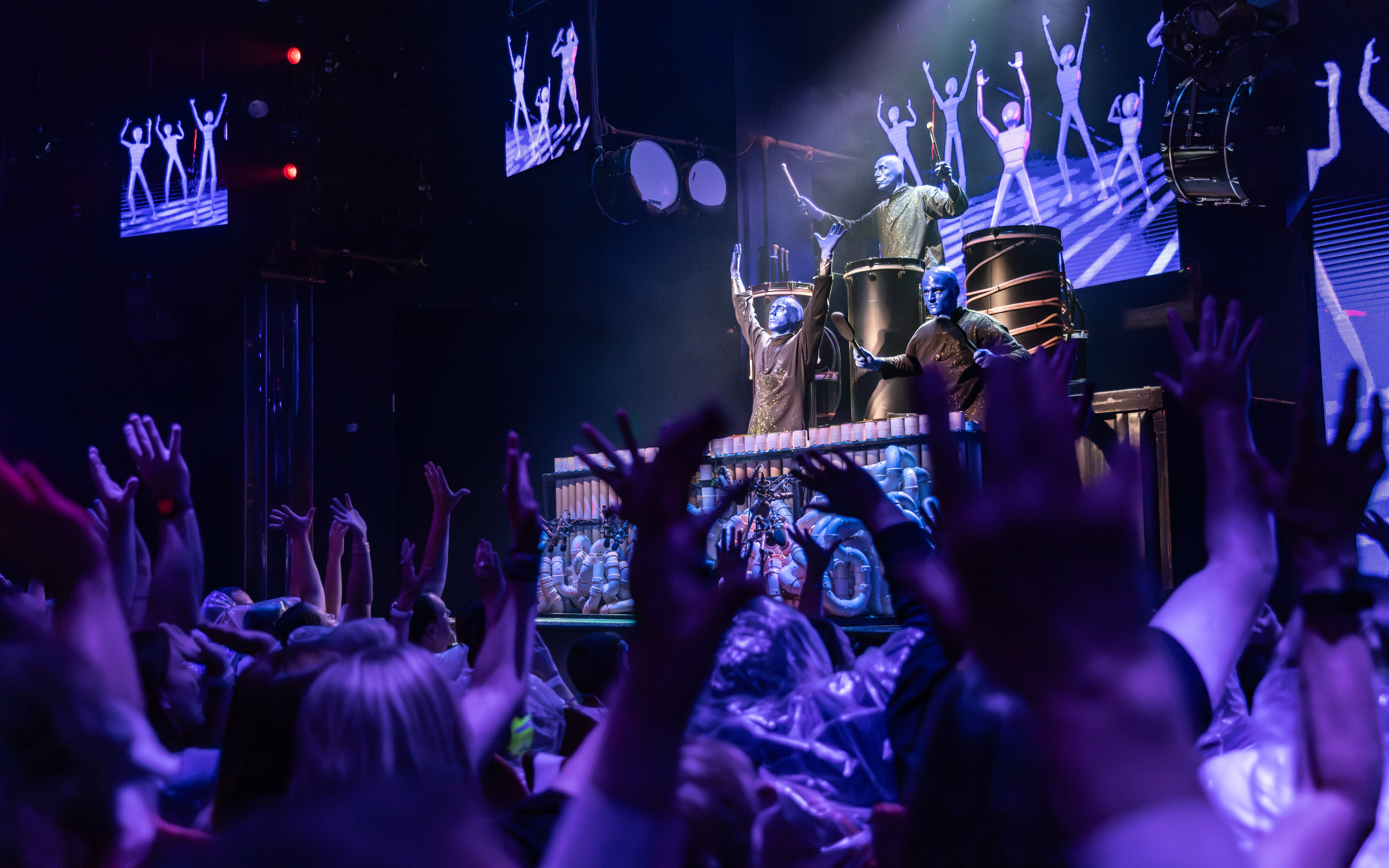 Blue Man Group performing on stage with audience in Orlando.