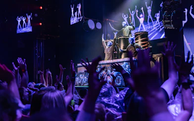 Blue Man Group performing on stage with audience in Orlando.