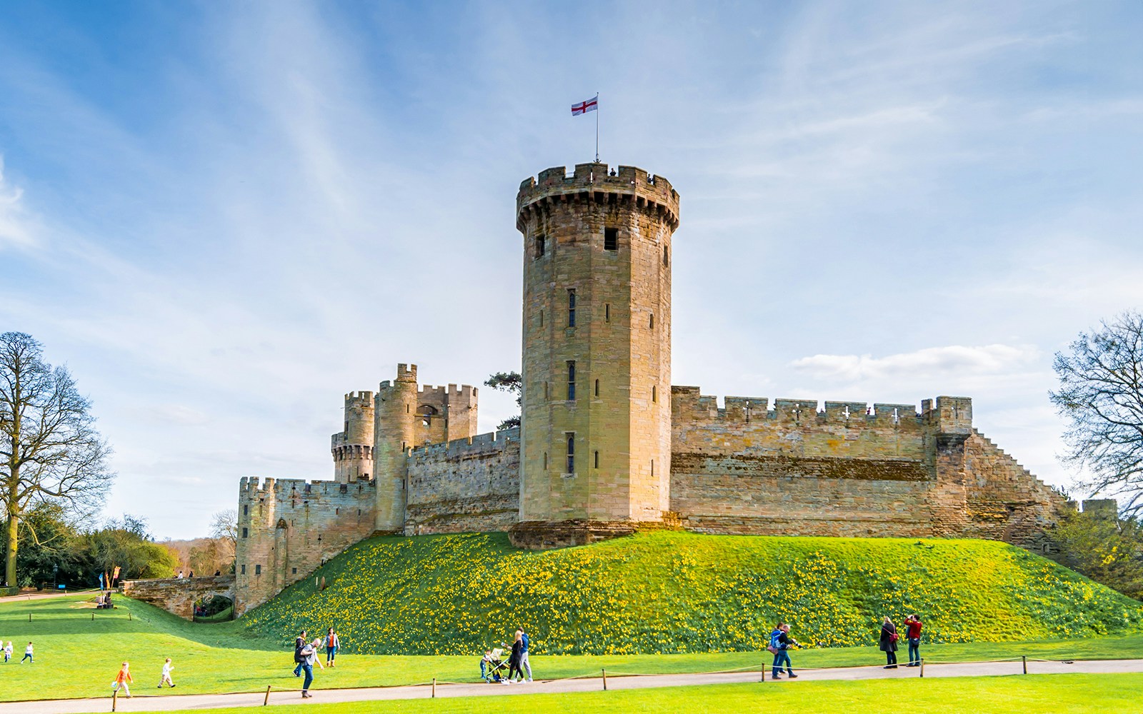 Warwick Castle East Front with tower and visitors on the lawn.