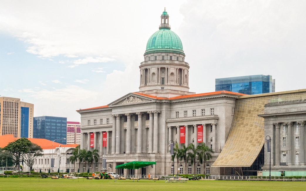 National Gallery Singapore exterior with dome and banners.