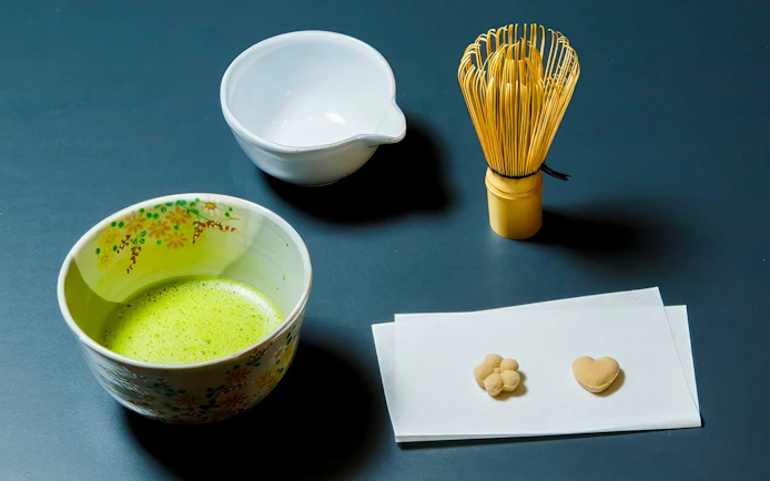 Matcha tea bowl, whisk, and sweets for tea ceremony in Kyoto Karasuma area.