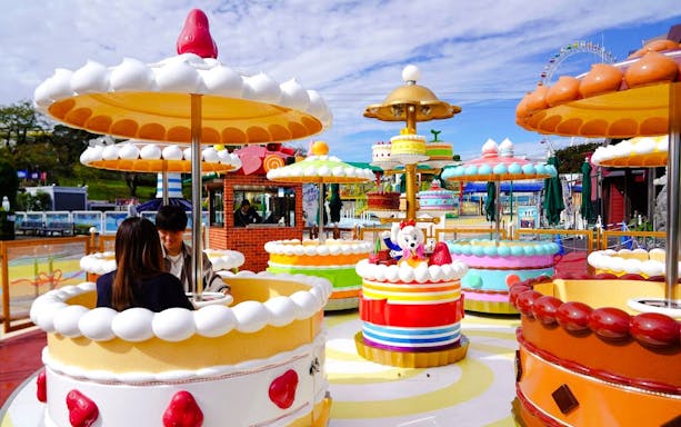 Colorful cake-themed ride at Yomiuriland amusement park in Tokyo, Japan.