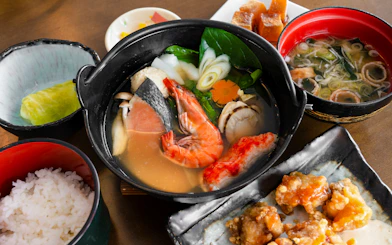 Traditional Japanese seafood hot pot with rice and side dishes, Sapporo to Bibai Snow Land tour, Hokkaido.