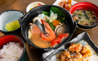 Traditional Japanese seafood hot pot with rice and side dishes, Sapporo to Bibai Snow Land tour, Hokkaido.