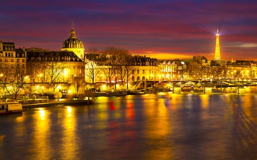 Paris night view with Eiffel Tower and Seine River, part of Tootbus Discovery Tour.