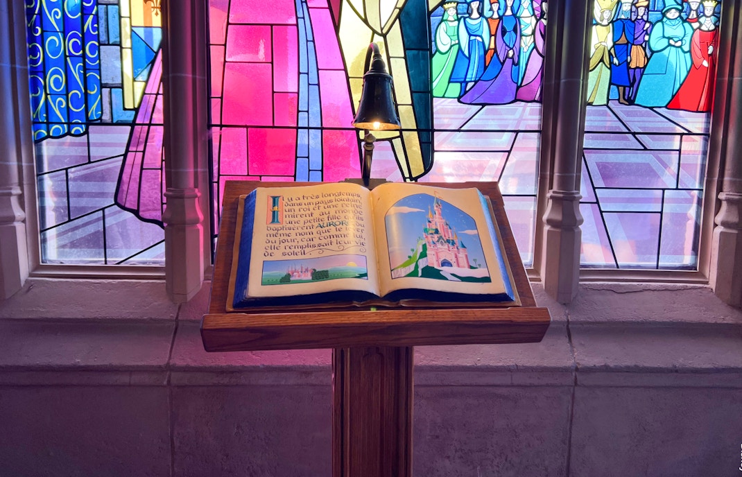 Sleeping Beauty Castle at Disneyland Paris with vibrant turrets and lush gardens.