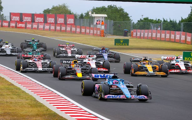 Formula 1 cars racing at the Hungarian Grand Prix track.