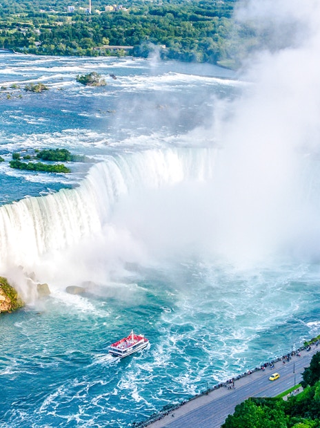 Aerial view of Niagara Falls with Horseshoe Falls and tour boat below.