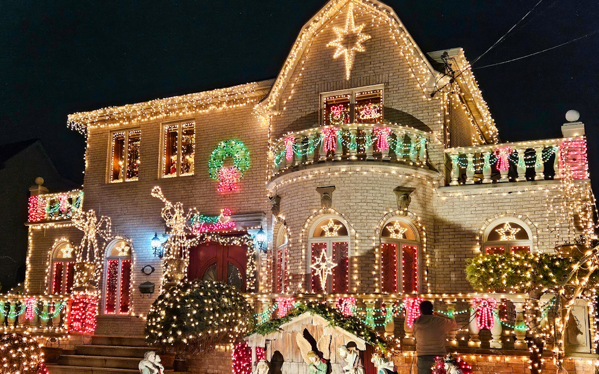 House adorned with colorful Christmas lights on New York Christmas Lights Bus Tour.
