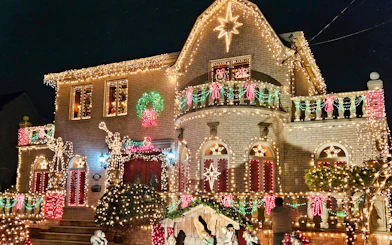 House adorned with colorful Christmas lights on New York Christmas Lights Bus Tour.