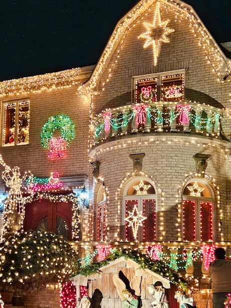 House adorned with colorful Christmas lights on New York Christmas Lights Bus Tour.