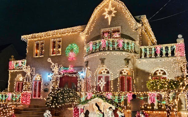 House adorned with colorful Christmas lights on New York Christmas Lights Bus Tour.