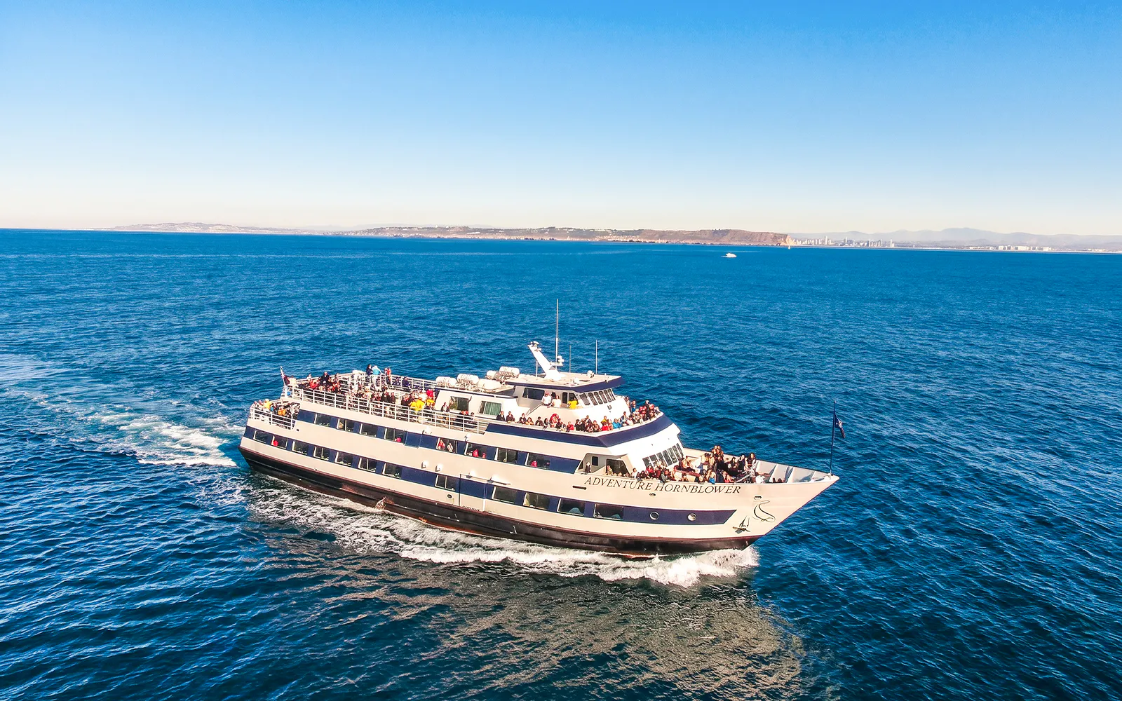 San Diego whale watching cruise ship on open ocean with passengers.