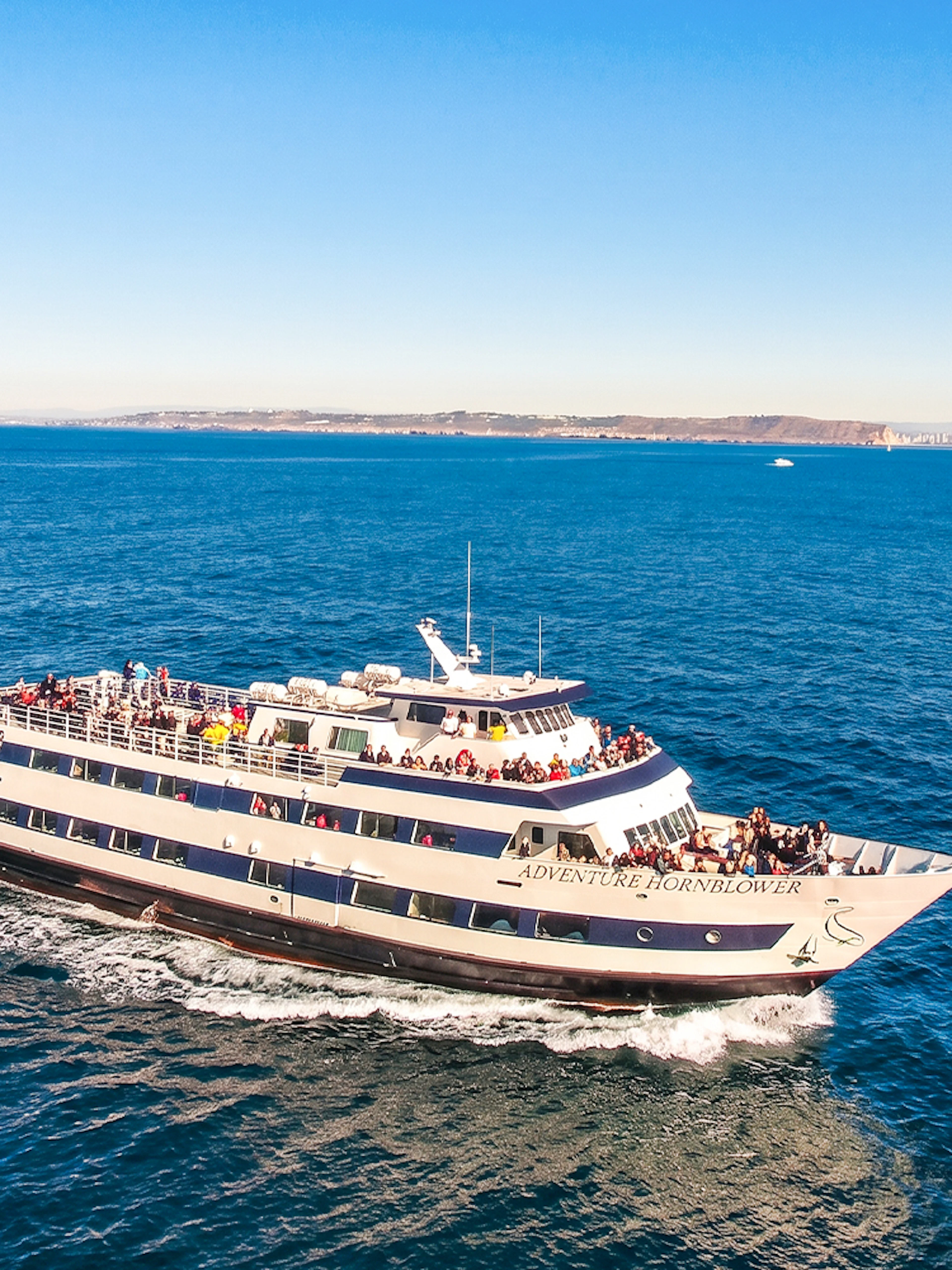 San Diego whale watching cruise ship on open ocean with passengers.