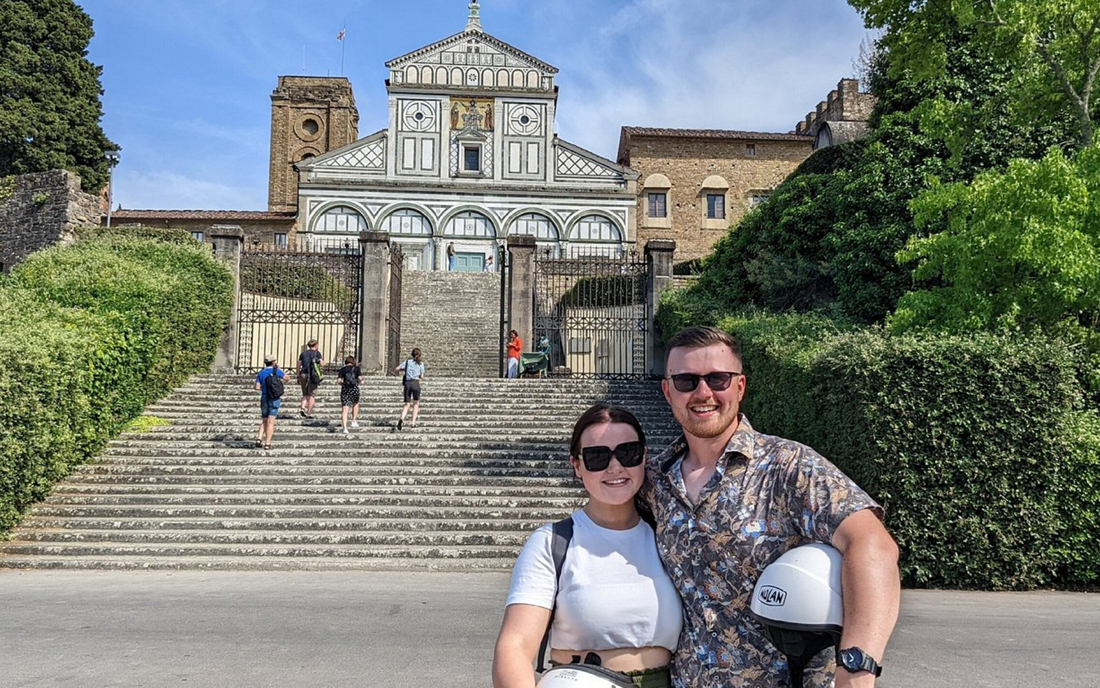 Giotto's Bell Tower in Florence with tourists exploring nearby monuments on a day trip.