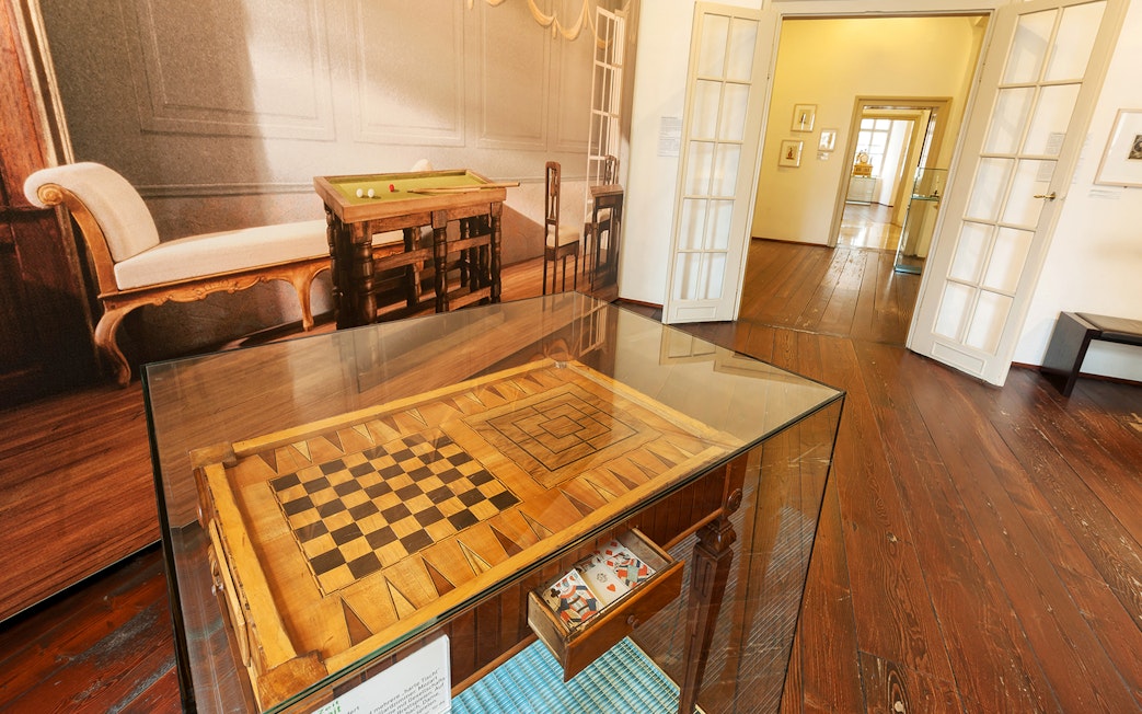 Chessboard display in Mozarthaus Vienna with period furniture in the background.
