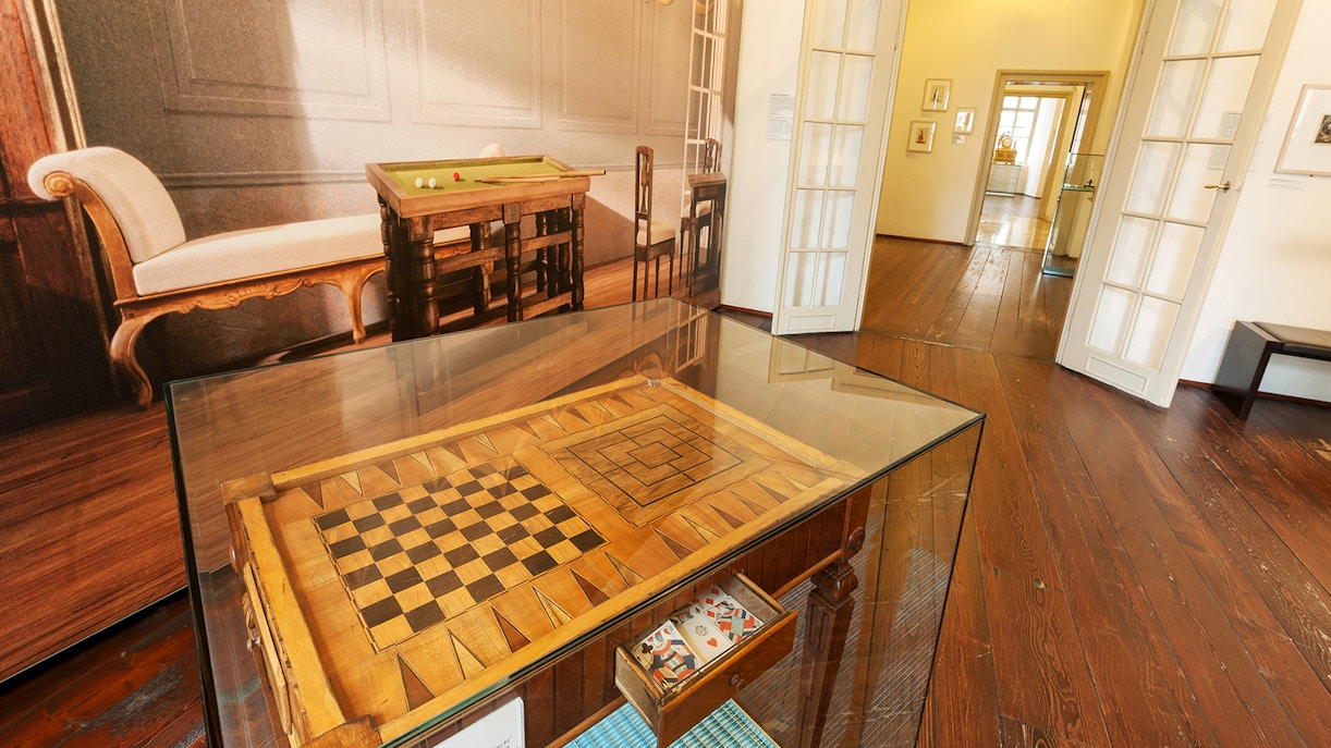 Chessboard display in Mozarthaus Vienna with period furniture in the background.