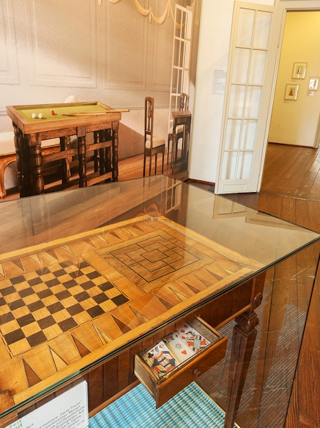 Chessboard display in Mozarthaus Vienna with period furniture in the background.