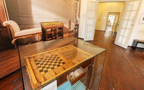 Chessboard display in Mozarthaus Vienna with period furniture in the background.