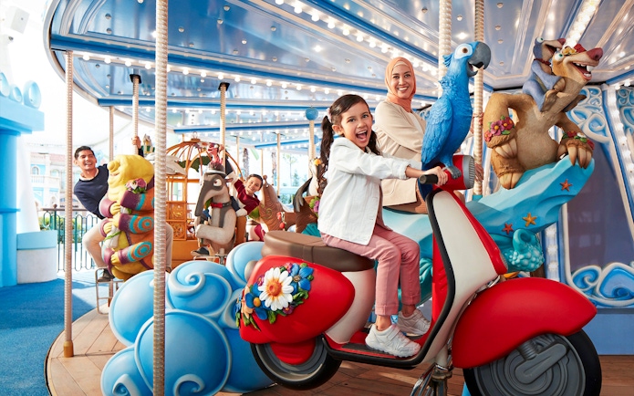 Visitors enjoying a colorful carousel ride at Genting SkyWorld Outdoor Theme Park.