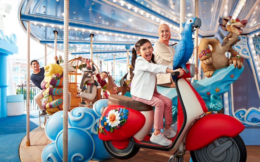 Visitors enjoying a colorful carousel ride at Genting SkyWorld Outdoor Theme Park.