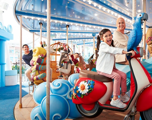 Visitors enjoying a colorful carousel ride at Genting SkyWorld Outdoor Theme Park.