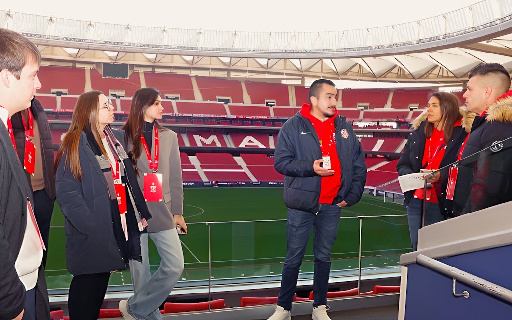 Tourists with guide at Cívitas Metropolitano stadium, Madrid, during a guided tour.