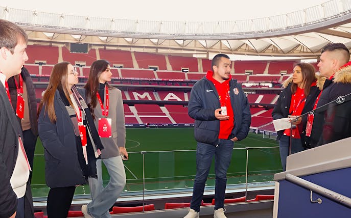 Tourists with guide at Cívitas Metropolitano stadium, Madrid, during a guided tour.