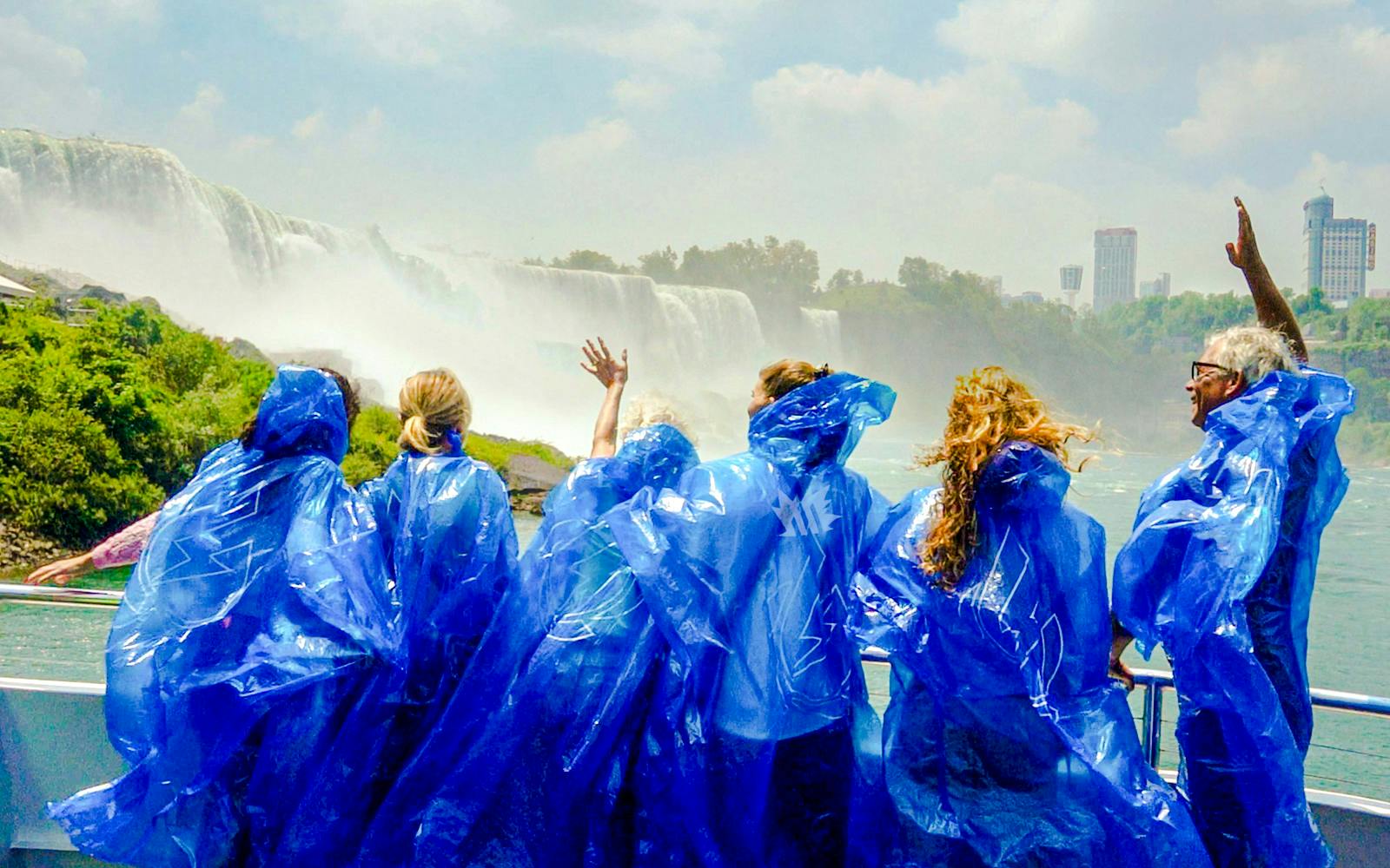 Visitors in blue ponchos on a boat tour at Niagara Falls, USA.