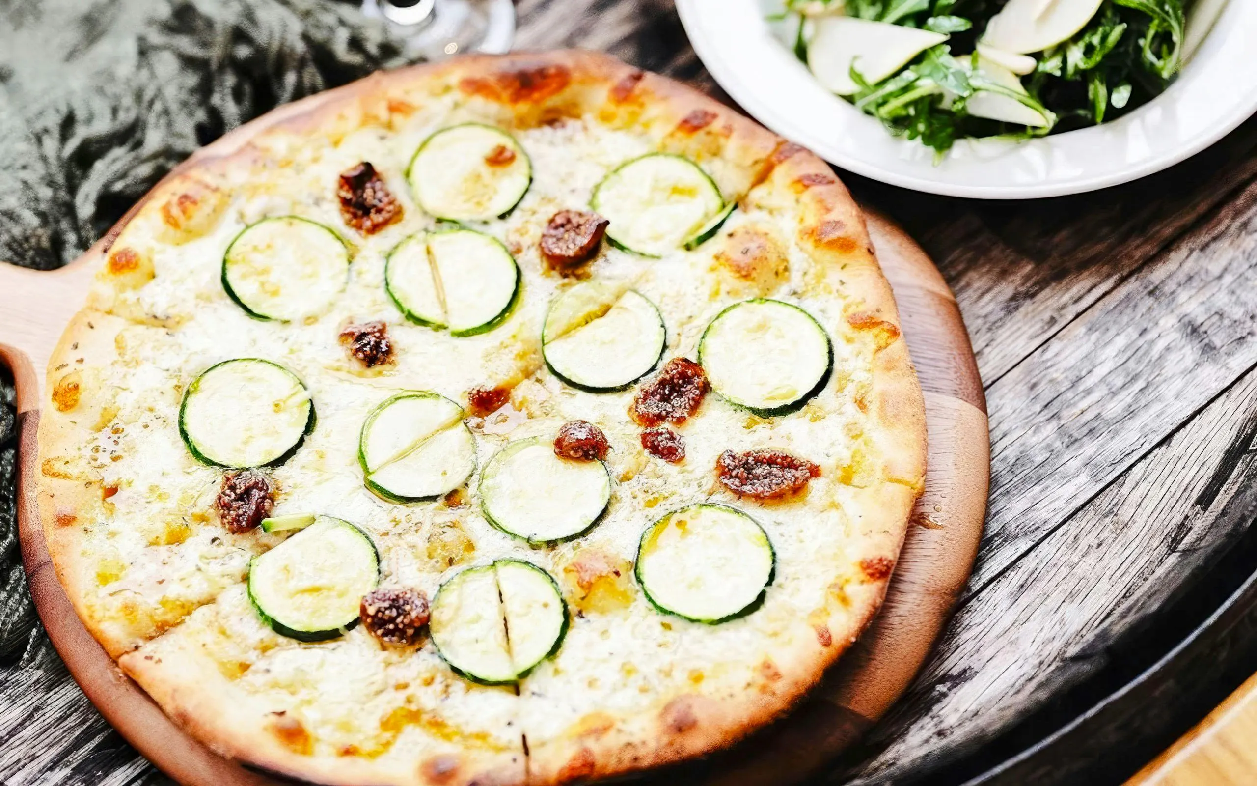 Zucchini and fig pizza served on a wooden board during Yarra Valley Winery Tour.