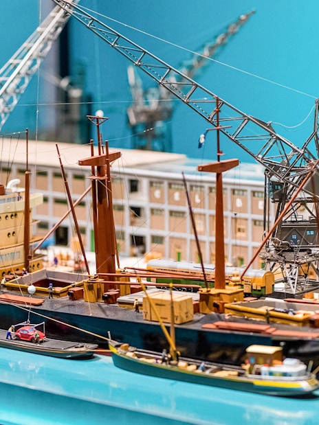 Model ship and cranes exhibit inside The Maritime Museum, Amsterdam.
