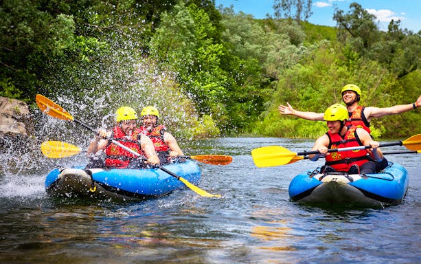 Canoe Safari tour from Split with people paddling on a river, surrounded by lush greenery.