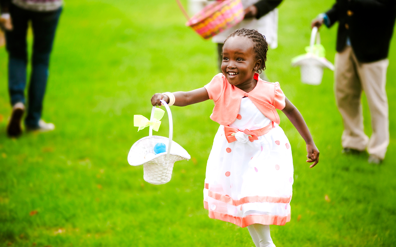 Girl running in park with basket of Easter eggs, celebrating Easter event.