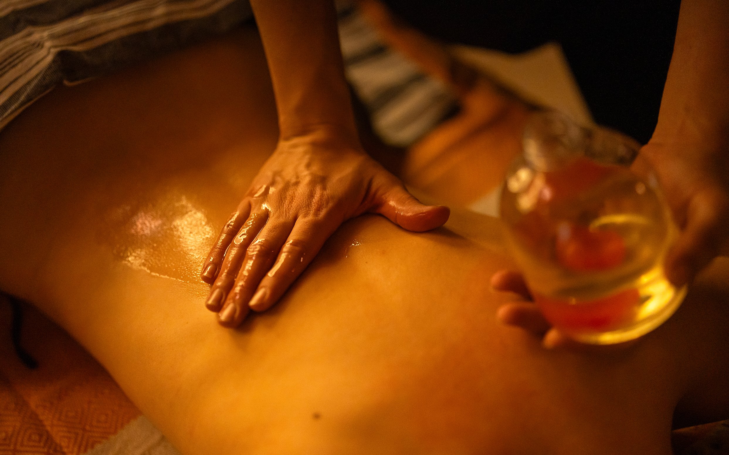 Massage therapist applying oil during Traditional Hammam in Granada.