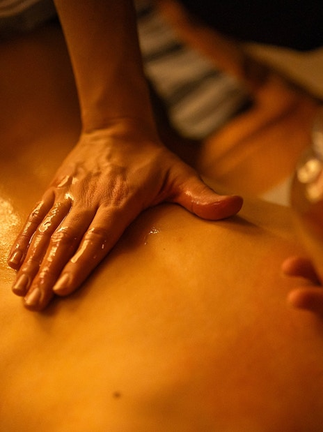 Massage therapist applying oil during Traditional Hammam in Granada.