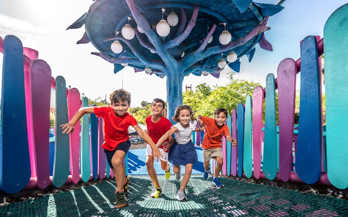Children playing at Isla Mágica amusement park, Seville, Spain.