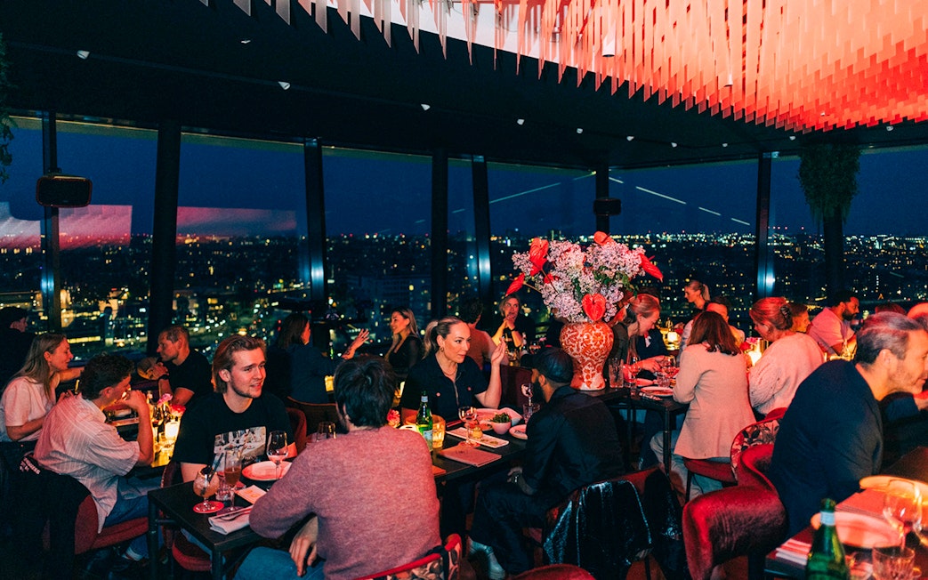 Dinner guests enjoying city views at Madam Skybar Restaurant.