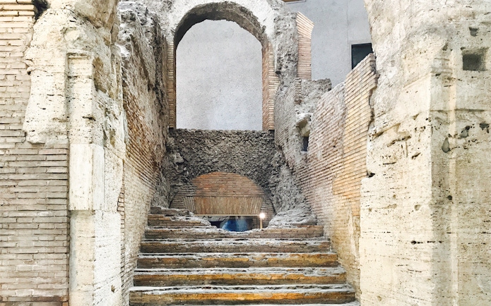 Ancient stone steps leading to an archway in Domitian Stadium, Rome.