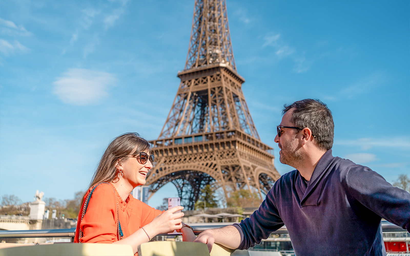 Champagne toast on Seine River Cruise with Eiffel Tower in background.