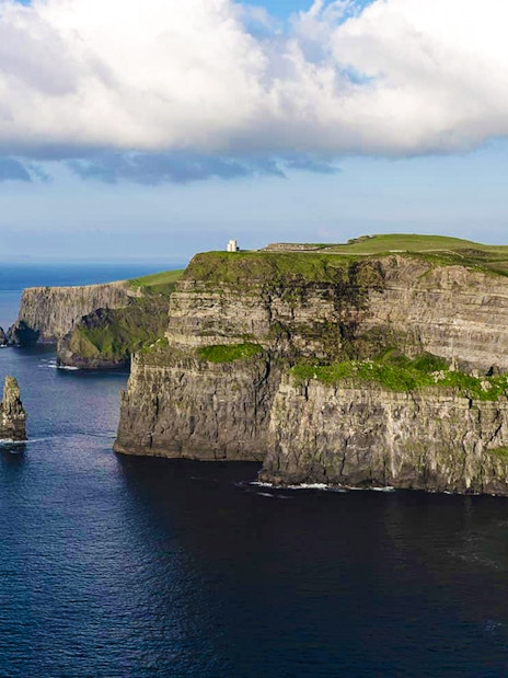 Cliffs of Moher, Ireland, with ocean view and green landscape.