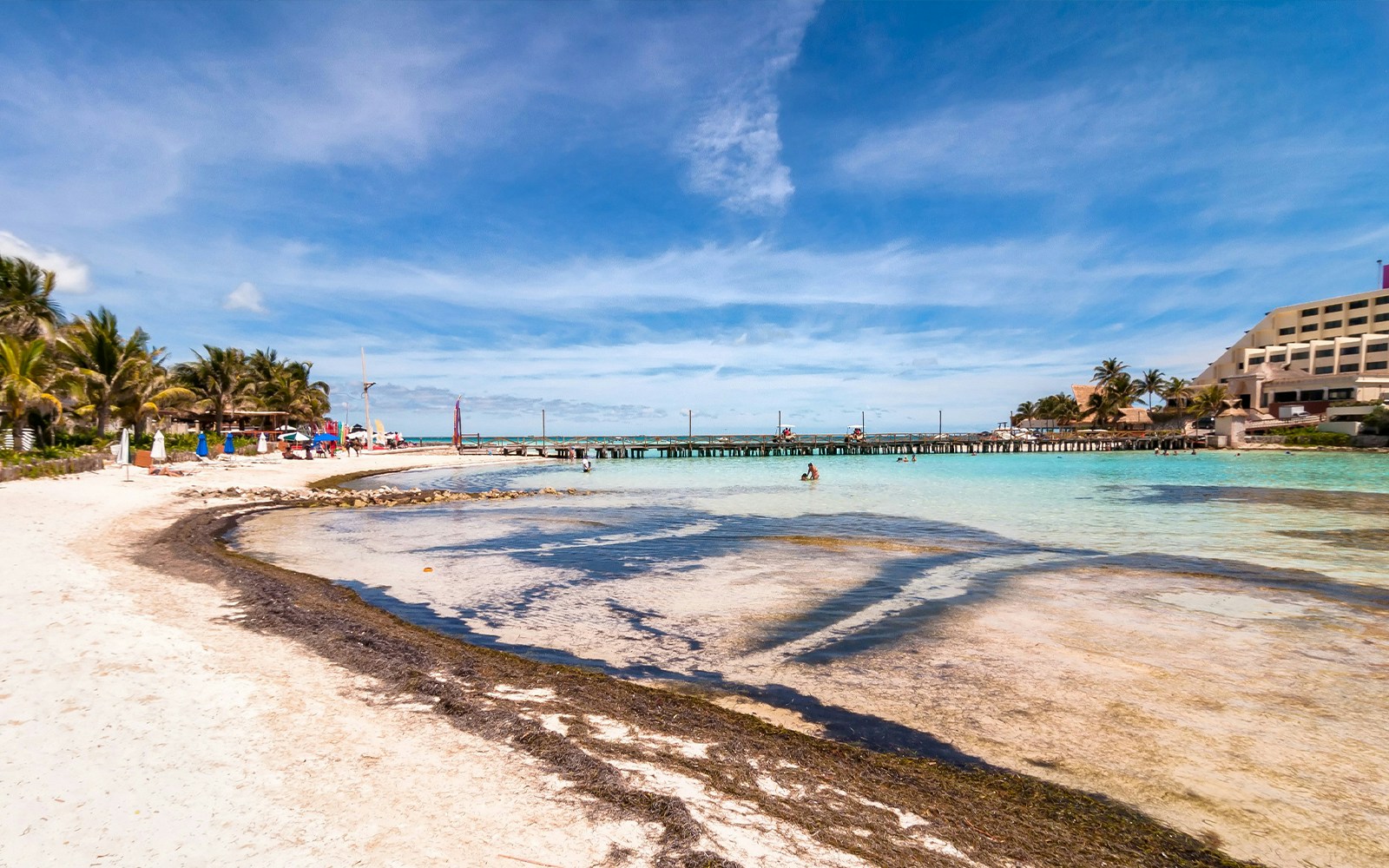 Catamaran dock and beach on Isla Mujeres with clear blue water.