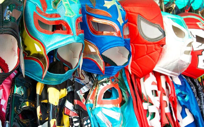 Colorful Lucha Libre masks displayed in a market in Mexico.