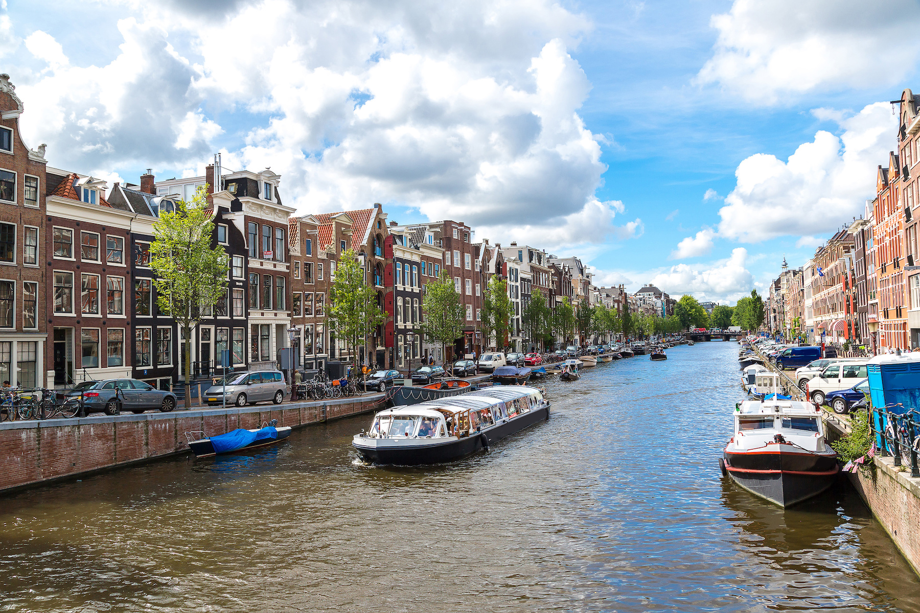 Canal boat tour on Amsterdam's historic waterways with traditional Dutch buildings.