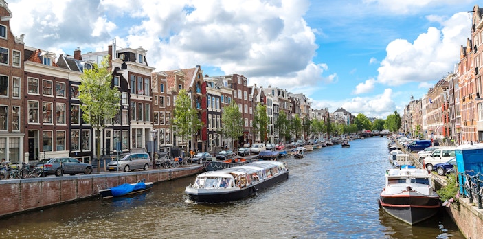Canal boat tour on Amsterdam's historic waterways with traditional Dutch buildings.