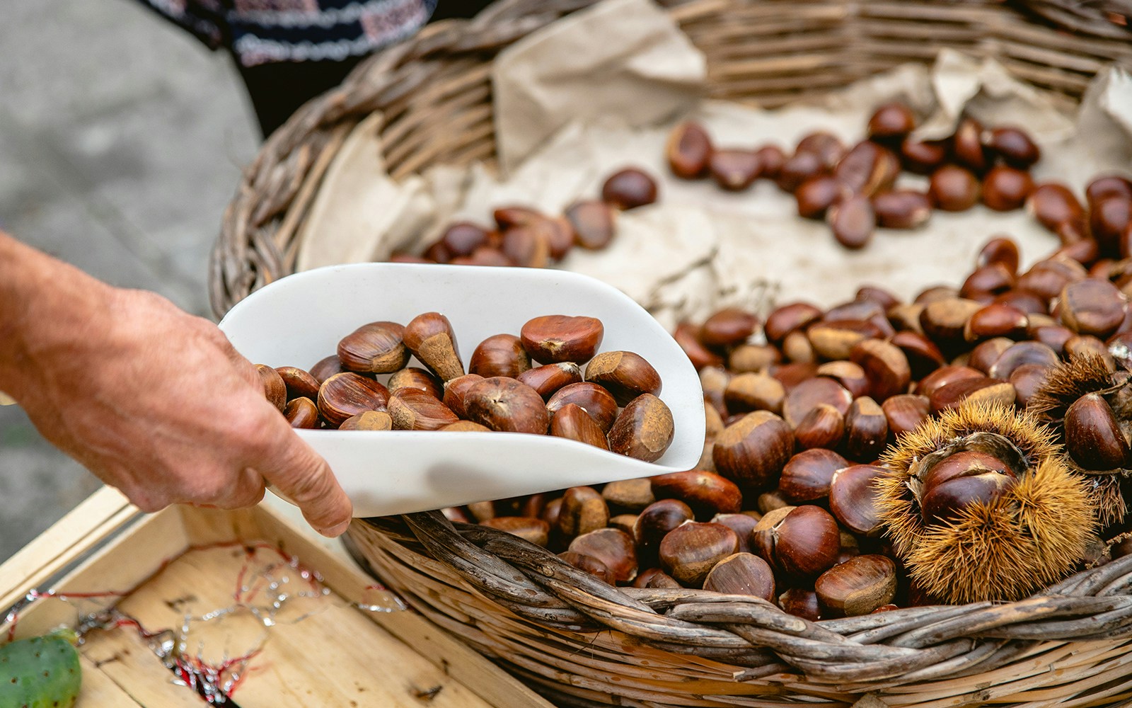 Ortigia market vendor displaying fresh produce during cooking class tour in Siracusa, Italy.