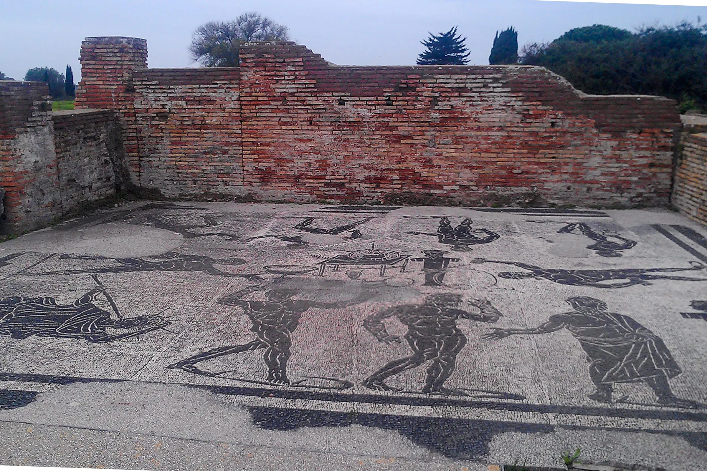 Mosaic floor with ancient Roman figures at Ostia Antica Archaeological Park, Rome.