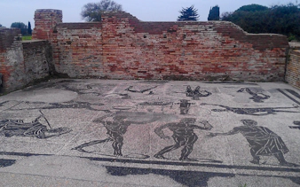 Mosaic floor with ancient Roman figures at Ostia Antica Archaeological Park, Rome.